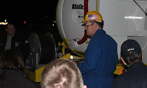 Rich Muellerleile demonstrates the workings of a propane delivery truck to a group of local first responders.